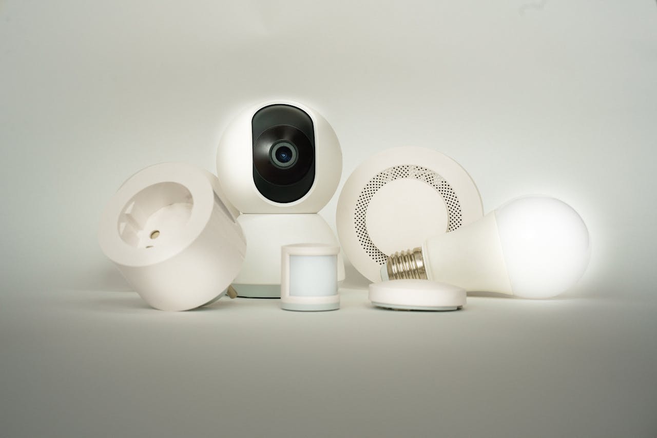 A collection of smart home devices, including a camera, light bulb, and sensors, on display.